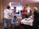 WRTC-2014 competitors check in at the headquarters hotel following the event. Chief WRTC-2014 Judge David Sumner, K1ZZ, is on the right in the green shirt. [WRTC video]